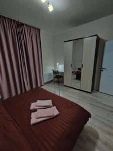 a bedroom with a bed with two towels on it at 2 комнатная Нурсат ЖК Алтын Шанырак in Shymkent
