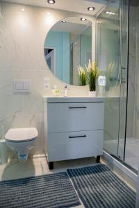 a bathroom with a toilet and a sink and a shower at Apartament Rio in Władysławowo