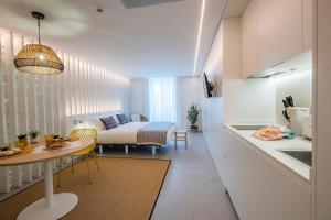 a small living room with a bed and a table at Apartamentos Atia Catedral in Santiago de Compostela