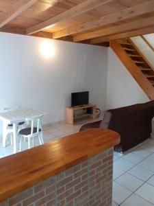 a living room with a couch and a table at DUPLEX HIBISCUS in Les Abymes