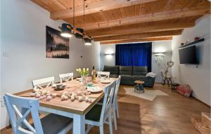 a dining room and living room with a table and chairs at Gorgeous Home In Varazdinske Toplice With Kitchenette in Varaždinske Toplice