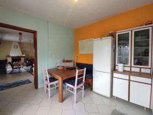 a kitchen with a table and a refrigerator at Pond and Pines, by nice house by the sea! in Epanomi