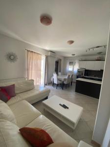 a living room with a white couch and a table at Mare in Brodarica