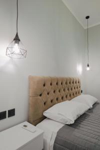 a bedroom with a large bed with a large headboard at Iphigenia Luxury Flat in Sarandë