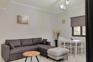 a living room with a couch and a table at Iphigenia Luxury Flat in Sarandë