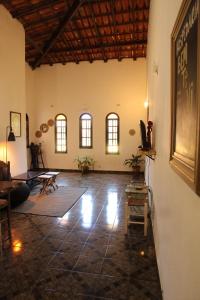 a large room with a table and chairs in it at Hostel Bem Te Vi Arraial d'Ajuda in Arraial d'Ajuda