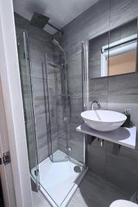 a bathroom with a shower and a sink at N 25 in Horley