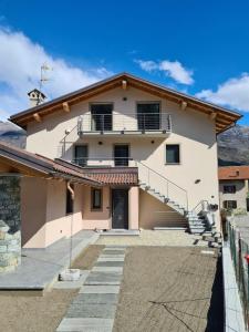 a large white house with stairs on it at Casa Vacanza Lo Nânò in Fenis