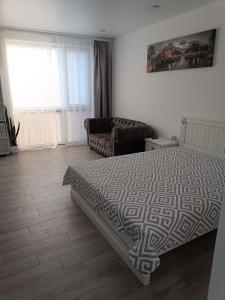 a bedroom with a bed and a couch at Apartment COMFORT on Ruska street in Chernivtsi