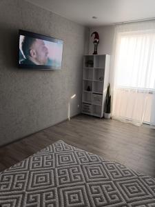 a living room with a flat screen tv on the wall at Apartment COMFORT on Ruska street in Chernivtsi