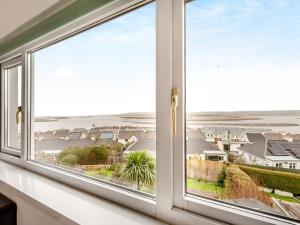 a window with a view of the beach at The Mount in Appledore