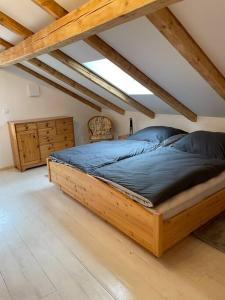 a bedroom with a large wooden bed in a attic at Ferienwohnung Aussicht, Monheimer Alb, Altmühltal 