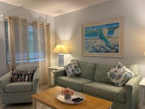 a living room with a couch and a table at An Island Getaway at Palm Tree Villas in Holmes Beach