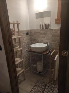 a bathroom with a white sink and a mirror at B&B Max & Lory in Neviano degli Arduini