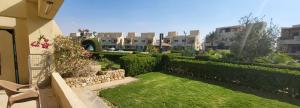 a yard with a fence and a lawn with a chair at Mousa Cost Resort عائلات فقط in Ras Sedr