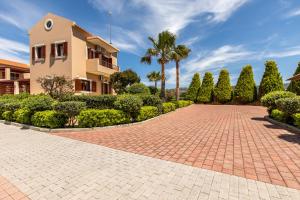 a brick driveway in front of a building at Gold Crest Home in Drapanias beach, Nopigia in Kissamos +32 photos