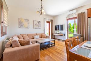 a living room with a couch and a table at Gold Crest Home in Drapanias beach, Nopigia in Kissamos