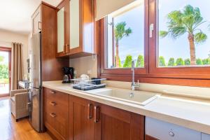 a kitchen with a sink and a window at Gold Crest Home in Drapanias beach, Nopigia in Kissamos