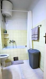 a bathroom with a tub and a toilet and a sink at Stan na dan ELF in Mostar