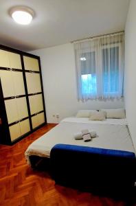 a bedroom with a large bed with two towels on it at Stan na dan ELF in Mostar