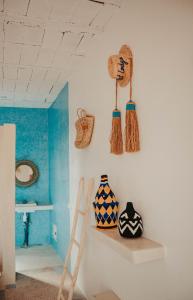 a room with a ladder and vases on a wall at Aghmat Lodge Guest house in Marrakech