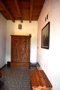 Habitación con puerta de madera y mesa de madera. en Hotel Casa Alvarada, en Comala