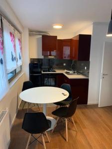 a small kitchen with a white table and chairs at Penthause StAnto, novogradnja, blizina Maksimira in Zagreb