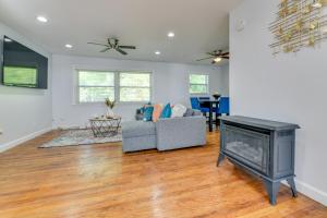 a living room with a fireplace and a couch at East Point Vacation Rental about 10 Mi to Downtown ATL in Atlanta