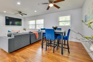a living room with a couch and a table and chairs at East Point Vacation Rental about 10 Mi to Downtown ATL in Atlanta