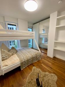 a bedroom with two bunk beds and a mirror at Stadt Villa Rastatt in Rastatt