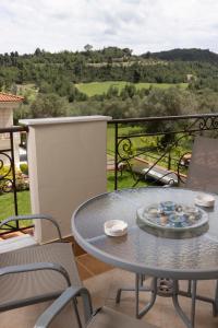 a table and chairs on a balcony with a view at Holiday Villa in Pefkochori
