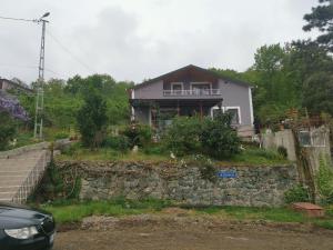 a house sitting on top of a stone wall at Said Paradise in Akcaabat