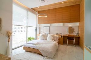 a bedroom with a bed and a desk in it at The Residence by Andaman Villa in Phuket Town