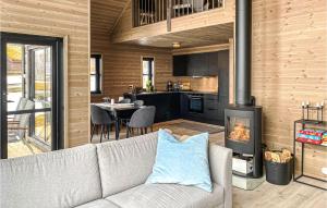 a living room with a couch and a stove at Lovely Home In Vikes With Kitchen in Vikeså