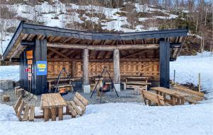 a wooden shelter with benches in the snow at Lovely Home In Vikes With Kitchen in Vikeså