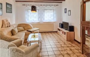 a living room with a couch and a tv at Ferienhaus 5 In Thalfang in Thalfang