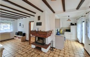 a living room with a fireplace and a kitchen at Ferienhaus 5 In Thalfang in Thalfang