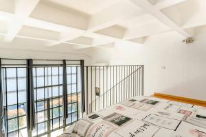 a bedroom with a bed and a balcony at Luxury Loft a Milano - Design esclusivo e comfort moderno in Milan