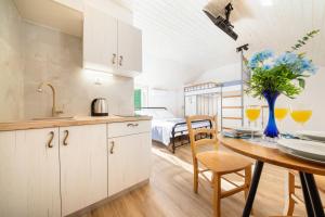 a kitchen and dining room with a table and a bed at Apartments Jerolim in Split