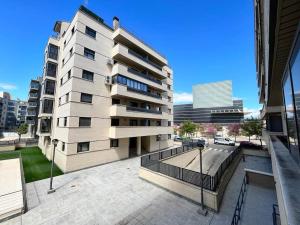 a large apartment building with a fence in front of it at El rincón de Martín en Huesca in Huesca