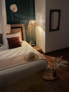 una camera da letto con un letto con un cappello sopra di FERRADURA EXCLUSIVE SEaVIEW a Búzios