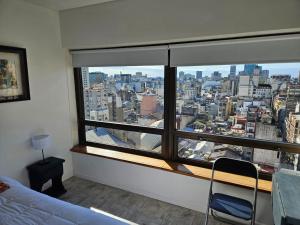a room with a large window with a city view at TroBaires in Buenos Aires