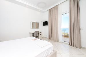 a hotel room with a bed and a window at Villa Luisanna Free Parking in Vlorë