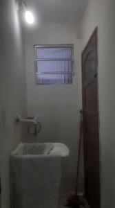 a bathroom with a bath tub and a window at Espaço Alternativo in Recife