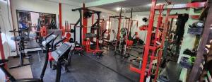 a gym with lots of equipment in a room at Apartahotel & Gym Rondon in Tortuguero