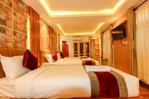 Voodi või voodid majutusasutuse Hotel Elegant Kathmandu Inn toas