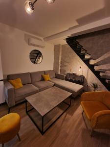 a living room with a couch and a table at Apartments Vraneš Tivat in Tivat
