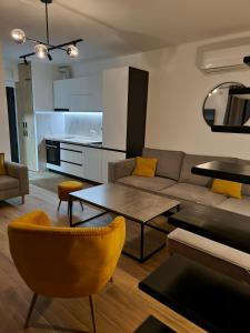 a living room with a couch and a table at Apartments Vraneš Tivat in Tivat