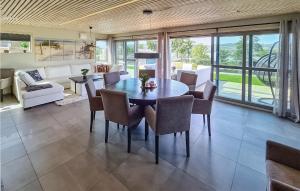 a dining room with a table and chairs at Cozy Home In Brevik With House Sea View in Brevik