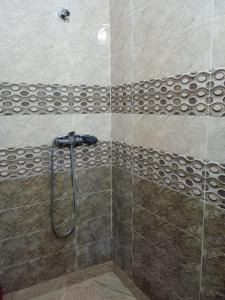 een douche met een douchekop in de badkamer bij Abla room in Azilal